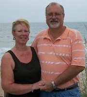 Picture of Gail & Harlan Banks standing beside the ocean.